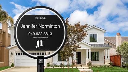 A For Sale sign with real estate agent Jennifer Normintons contact information stands in front of a modern two-story white house with a porch, trees, and a well-kept lawn under a blue sky with clouds.