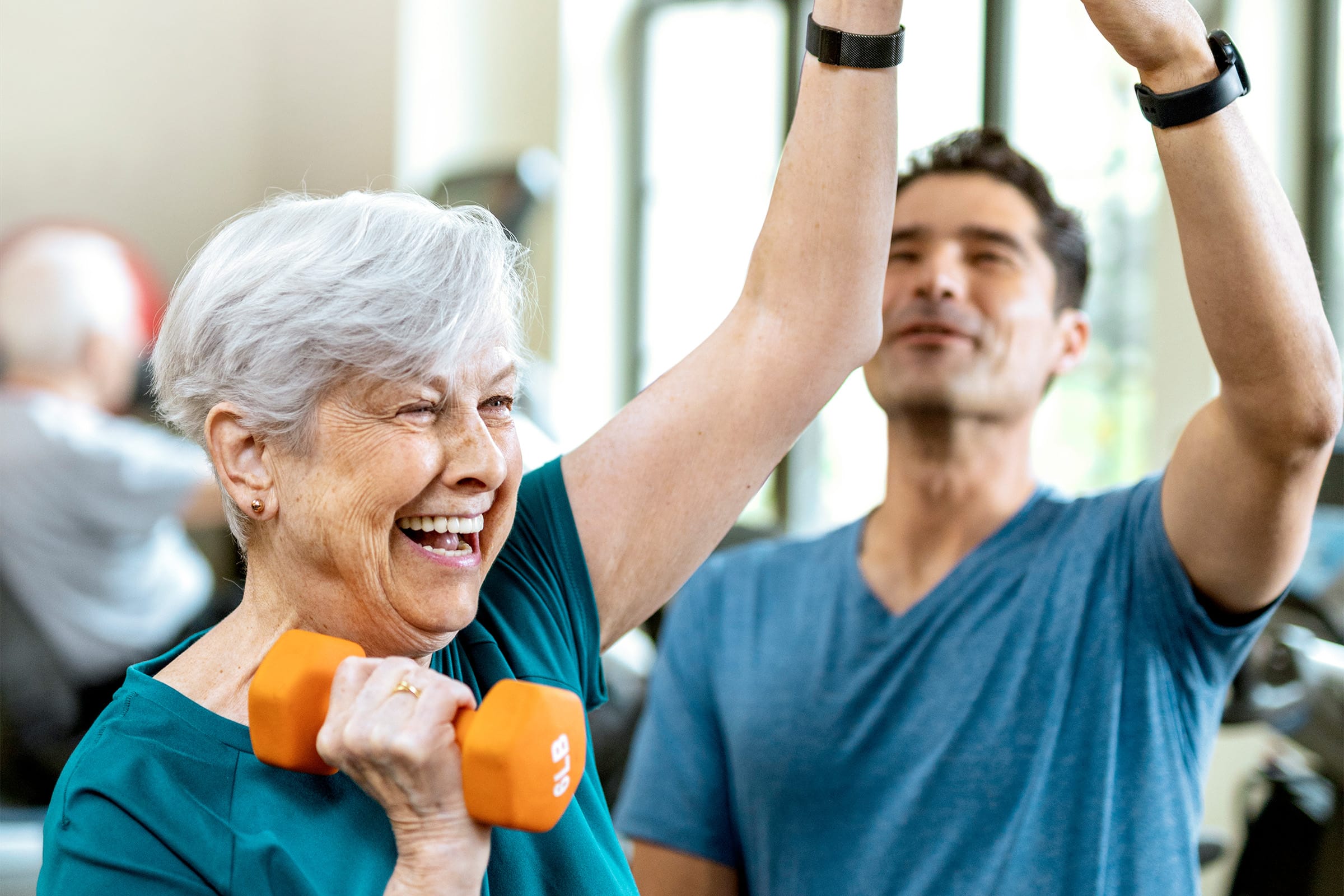 A senior resident at one of our active adult communities exercises with a physical trainer