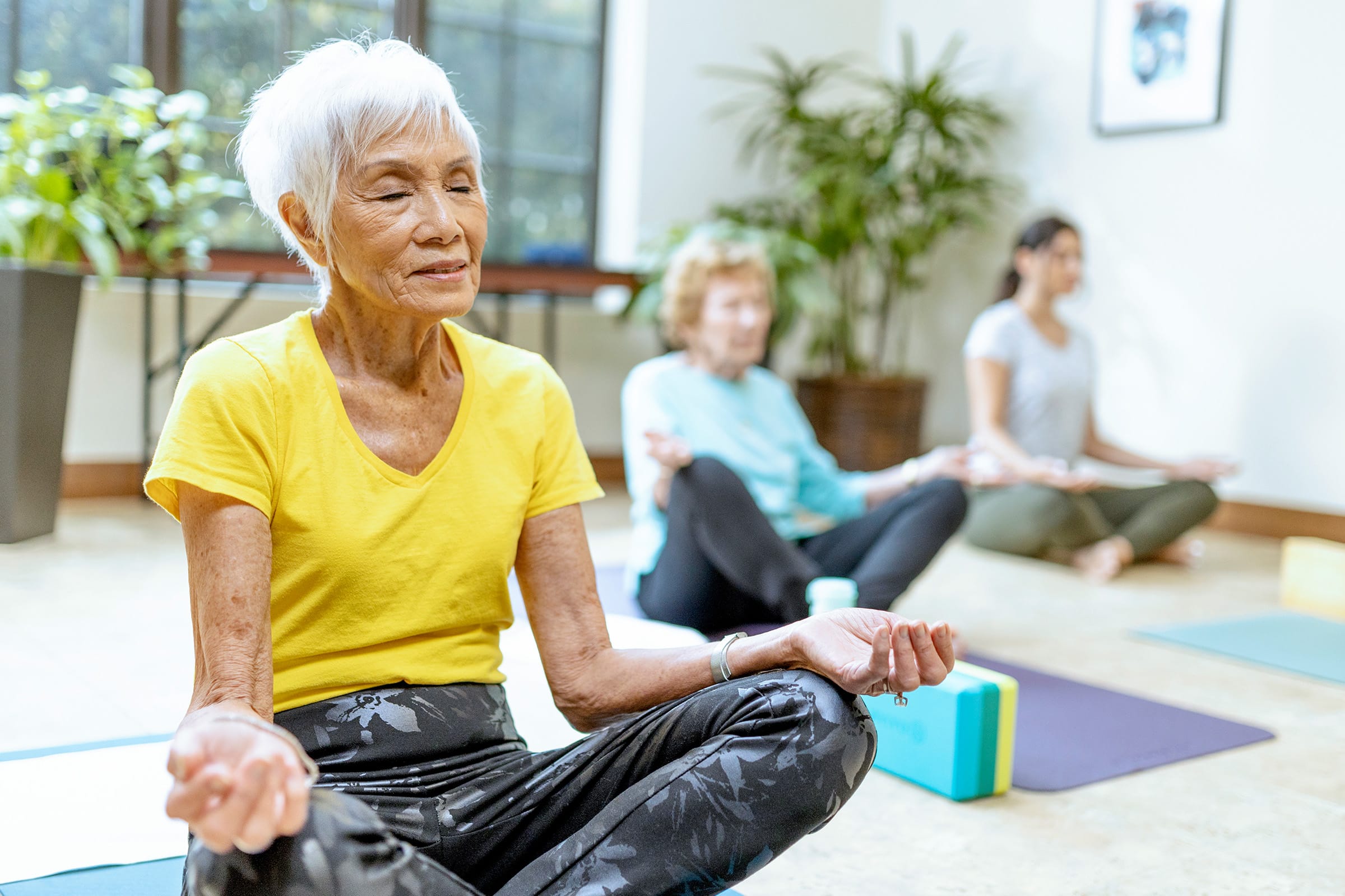 A relaxed senior woman meditates at one of the ECS's independent living communities.