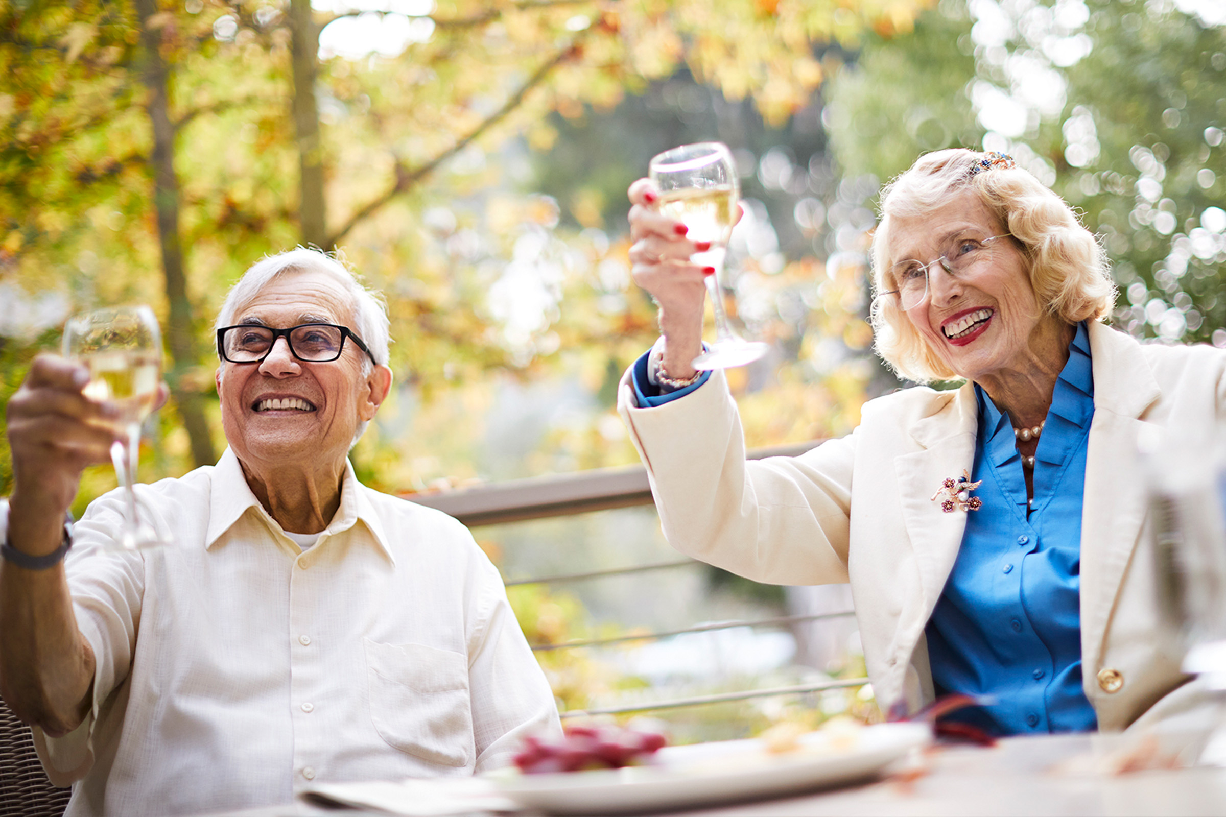 A couple toasts each other after planning their future at The Canterbury, a Life Plan senior home offering independent living in Los Angeles