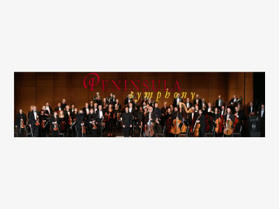 A large orchestra poses on stage with string, woodwind, brass, and percussion instruments; the words Peninsula Symphony are displayed in red and yellow behind them.
