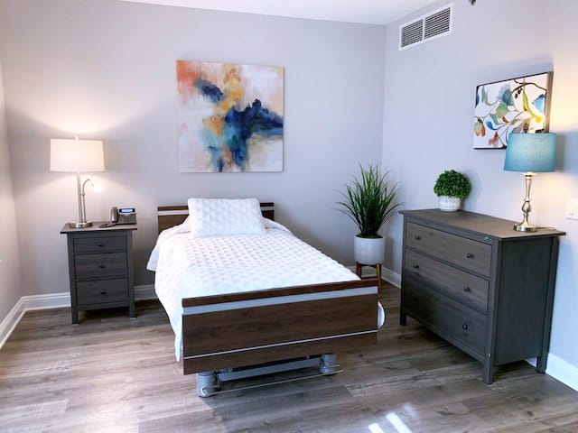 single bed with dressers and plants