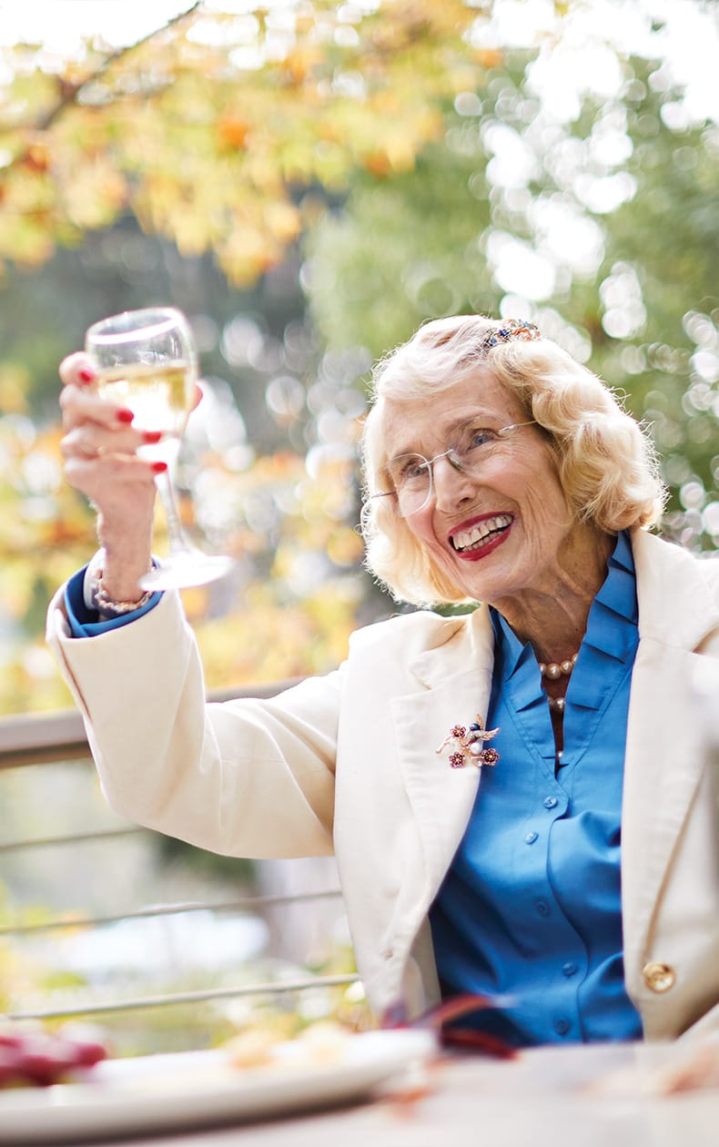 A couple toasts each other after planning their future at The Canterbury, a Life Plan senior home offering independent luxury senior living in Los Angeles.