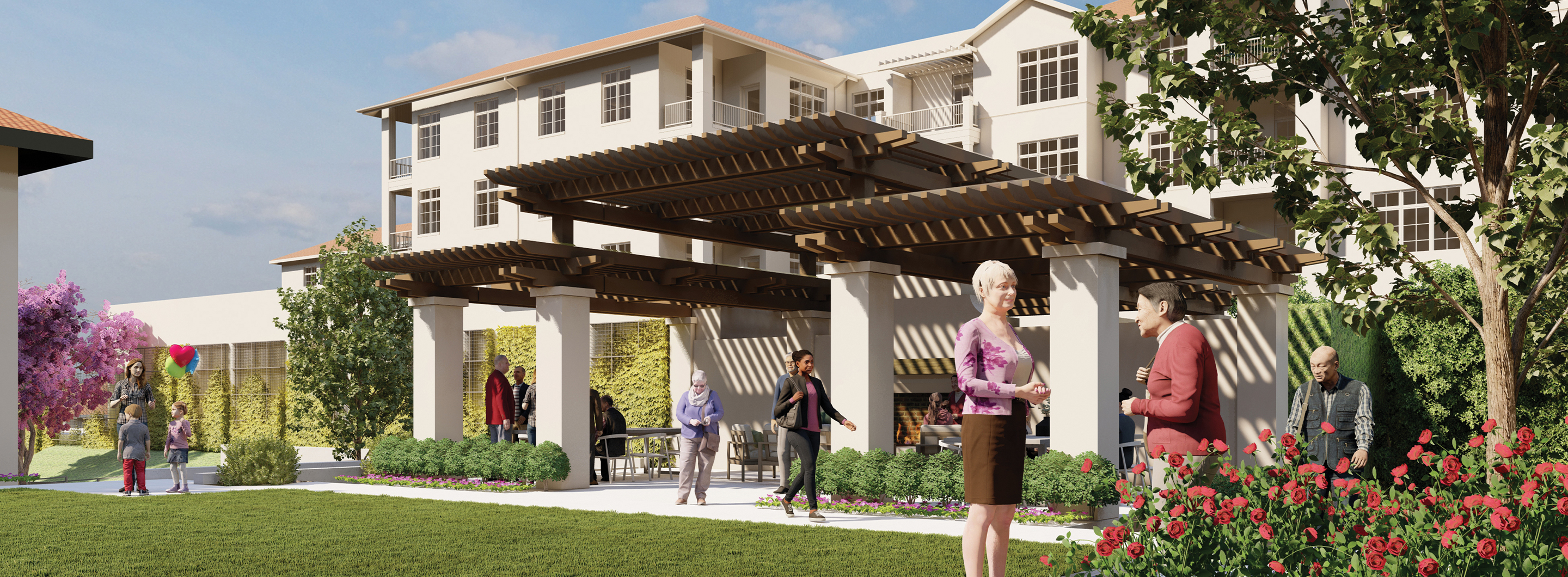 People socialize and enjoy a sunny day in a landscaped courtyard with a large pergola and garden, in front of a multi-story residential building. Some sit on benches, while others walk or stand among flowers and greenery.