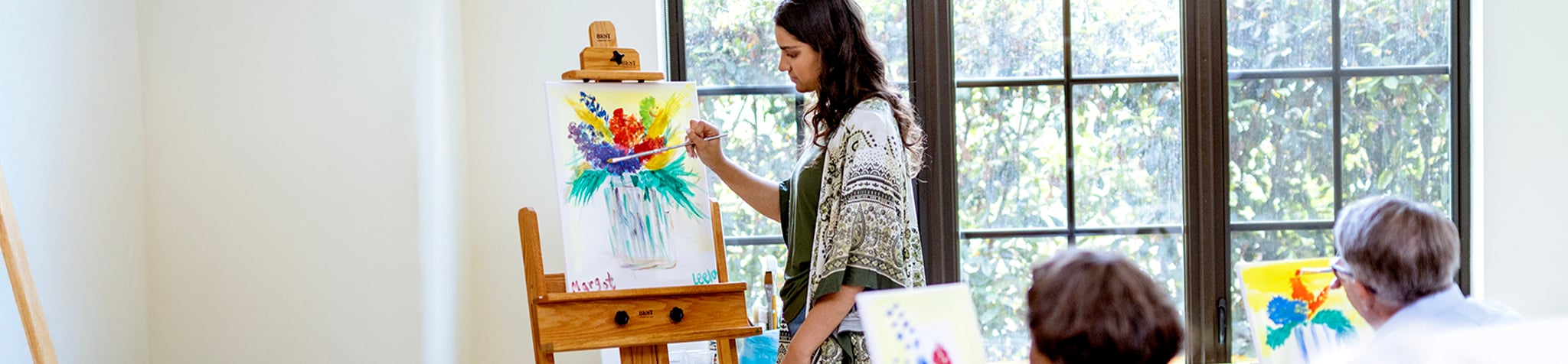 Art instructor demonstrates a painting technique at one of our active adult communities