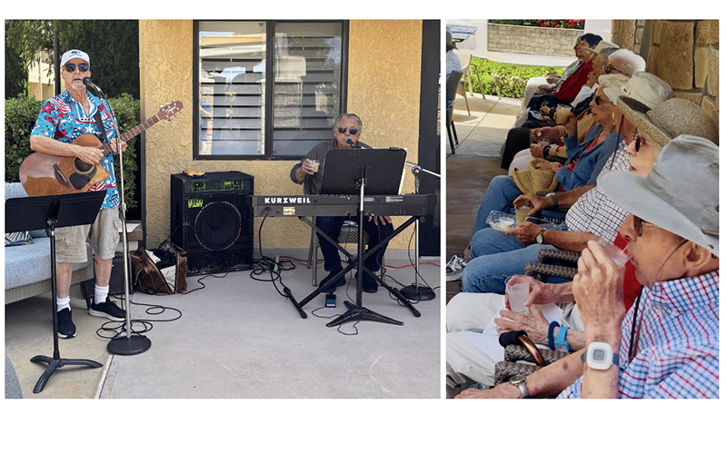 Two musicians perform with guitar and keyboard outdoors, while a row of elderly people sit in the shade, watching and listening, some wearing hats and sunglasses, holding drinks.