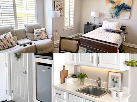 A cozy room with a bed, sofa, and colorful art, plus a bright kitchen with white cabinets, a sink, and decor on the counter.