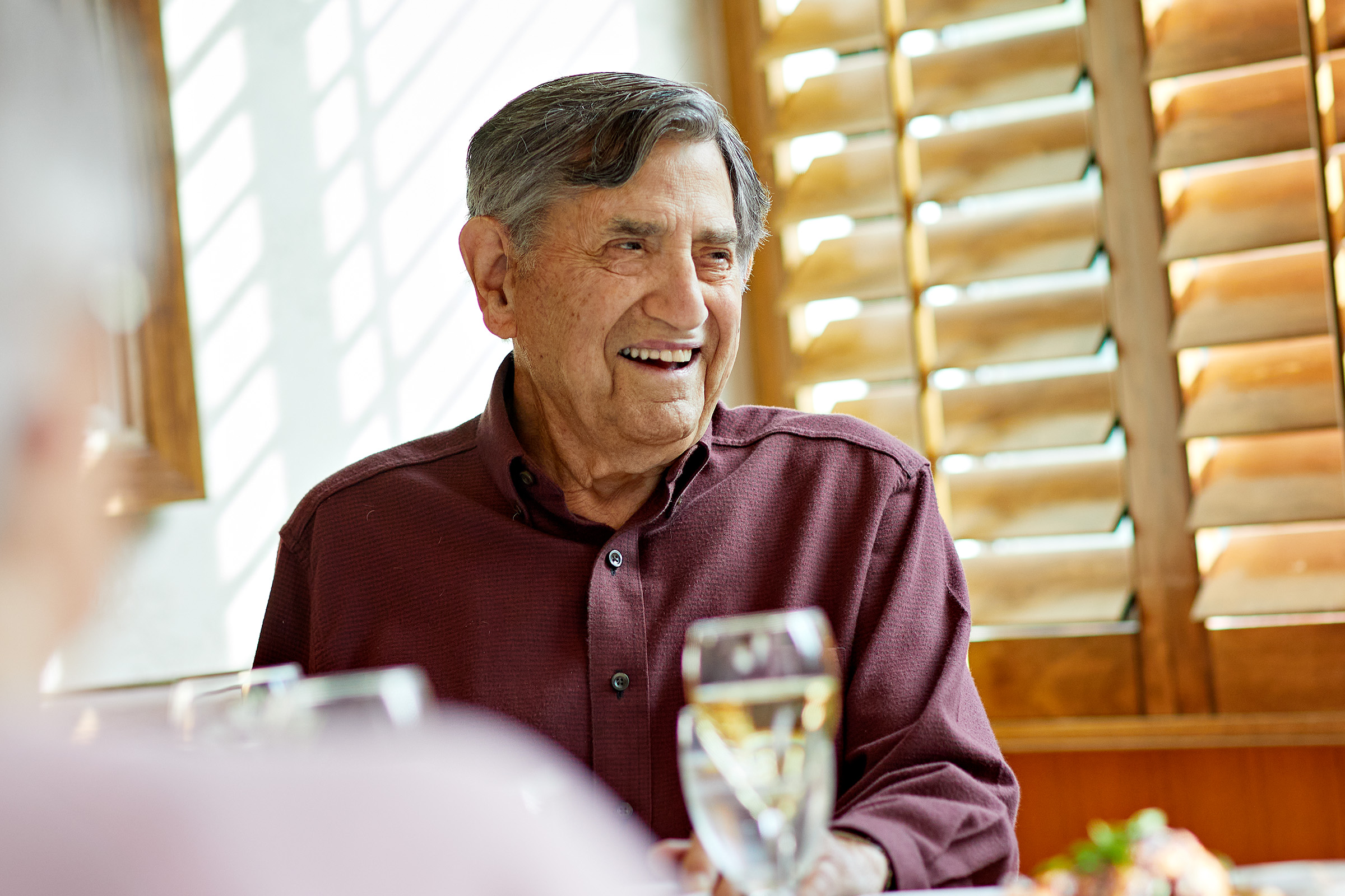 South Bay assisted living resident of the Canterbury smiling at a dining table