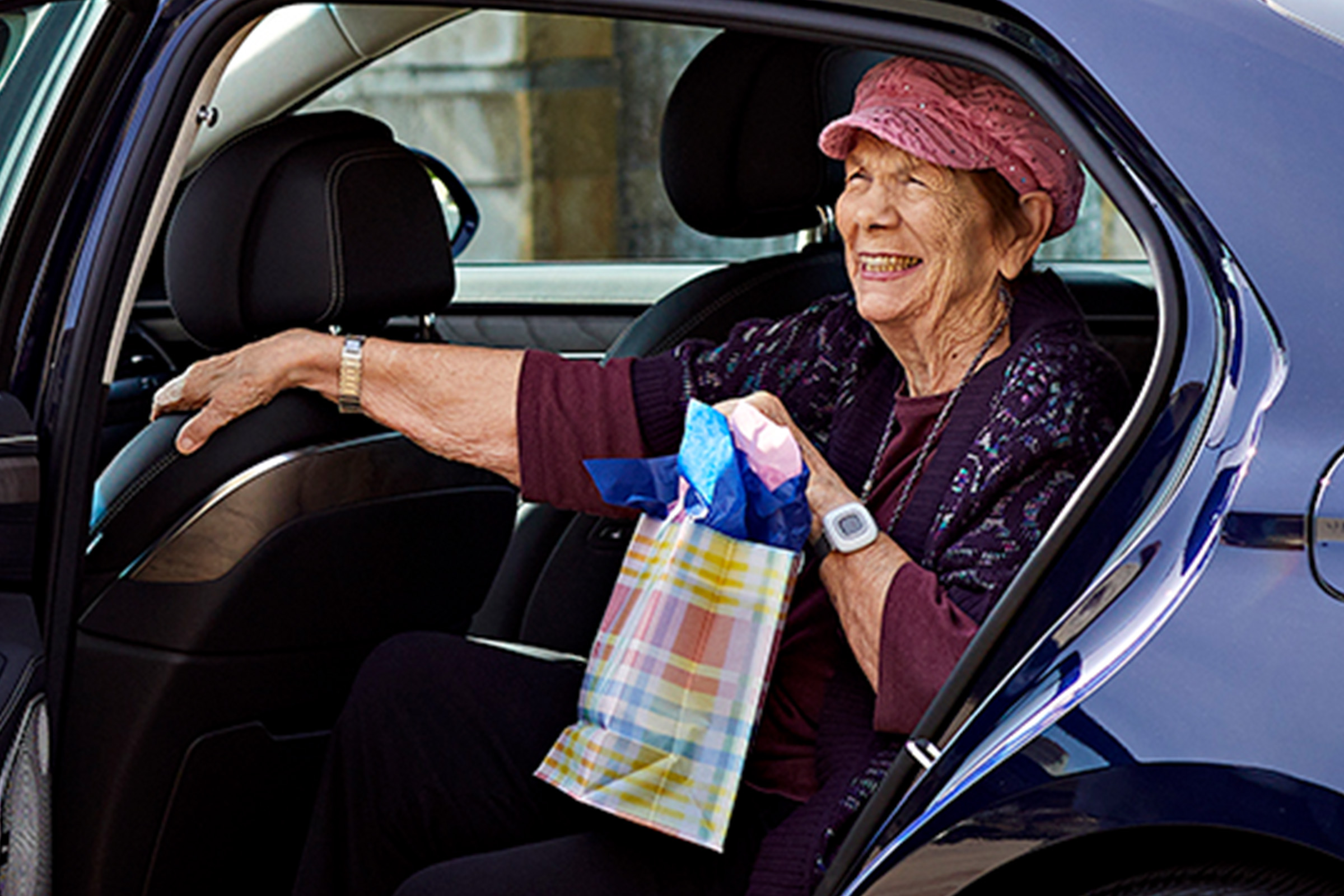 Happy resident with a gift enjoys the best assisted living in Los Angeles