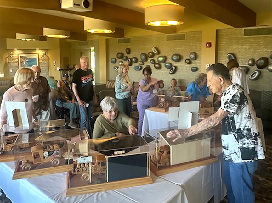 Residents displaying artwork during a community show and tell event.