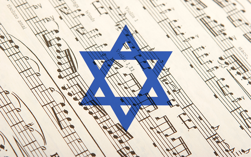 A blue Star of David is superimposed over sheet music, blending Jewish symbolism with musical notes and staffs in the background.
