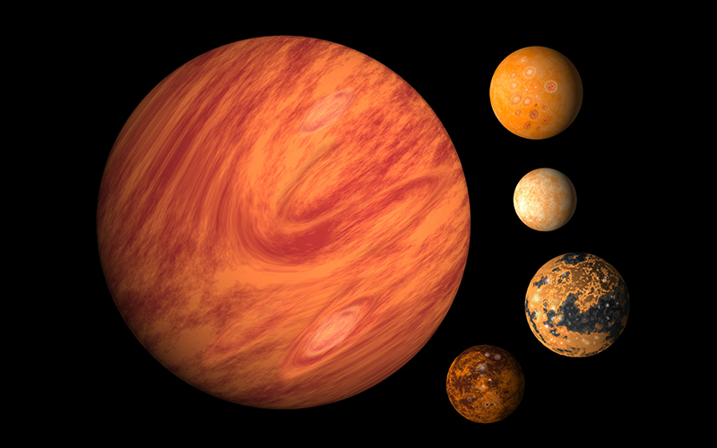 A digital illustration shows five planets of varying sizes and colors on a black background. The largest planet is orange with swirling patterns; the other four are smaller, featuring different textures and shades of orange, brown, and cream.